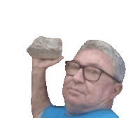 a man with glasses is holding a large rock in his hand