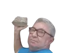 a man with glasses is holding a large rock in his hand