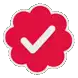 a red sticker with a white check mark in the middle .