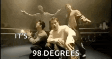 a group of men are dancing in a boxing ring in a video that says `` it 's 98 degrees '' .