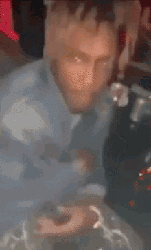 a blurry picture of a person 's hand making a middle finger gesture