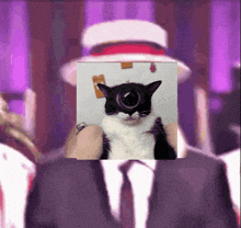 a man in a suit and tie is holding a black and white cat