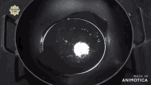 a person pouring something into a pot with the words made in animotica on the bottom