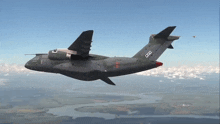 a military plane with the letters ccc on the tail is flying over a body of water
