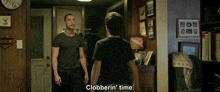 two men standing in a hallway with clobberin ' time written on the screen