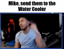 a man is sitting in front of a computer screen with the words `` mike , send them to the water cooler ''