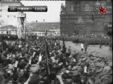 a crowd of people are gathered in front of a building with a sign that says mar 19 215