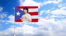 a flag with a picture of a man making a heart with his hands