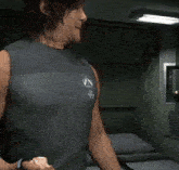 a man in a tank top with the letter a on the front
