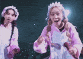 a girl in a pink outfit is holding a microphone in her hand