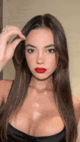 a woman wearing red lipstick and a black bra