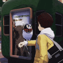 a person holding an owl in front of a sign that says ' a '