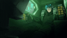 a man in a helmet is sitting in front of a computer screen that says ' r.i.t. ' on it