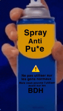 a person holding a spray can that says spray anti pu * e on it