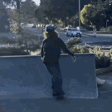 a person riding a skateboard down a street with cars parked in the background