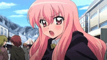 a girl with long pink hair is standing in a crowd of people .
