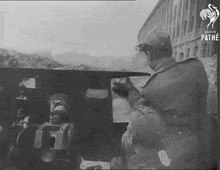 a black and white photo of soldiers with the pathe logo