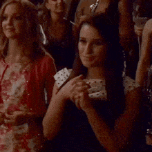 a woman in a polka dot dress smiles in a crowd