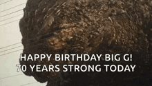 a close up of a monster with the words `` happy birthday big g ! 70 years strong today '' written on it .