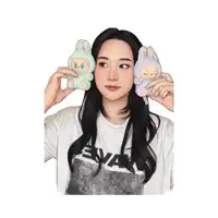 a woman wearing a wave shirt holds a stuffed animal