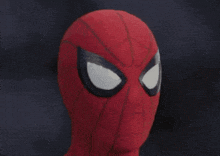 a close up of a spider man helmet with a spider web on it