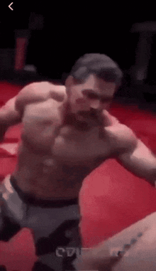 a man without a shirt is standing in a boxing ring with a belt that says c71 on it