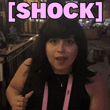 a woman is pointing at the word shock