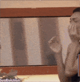 a woman covering her face with her hands in front of a mirror with the words " duoeviction " on the bottom right