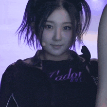 a close up of a woman wearing a black shirt that says " l' ador "