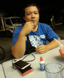 a man wearing a blue shirt that says metws your kids