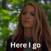 a woman says here i go in front of a green background