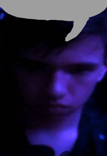 a close up of a person 's face with a blue background