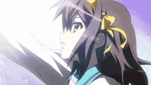 a girl with a yellow bow on her head is looking up