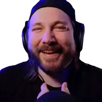 a man with a beard wearing headphones and a hat smiles