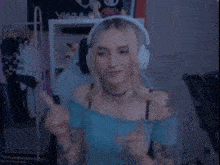 a woman wearing headphones is pointing at something