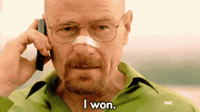 a man with glasses and a bandaged nose is talking on a cell phone .