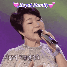 a woman singing into a microphone with the words royal family above her head
