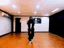 a person wearing a mask is dancing in a room with a wooden floor