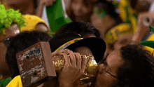 a man kissing a trophy that says ' champions league ' on it