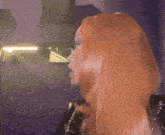 a woman with red hair is standing in front of a mirror