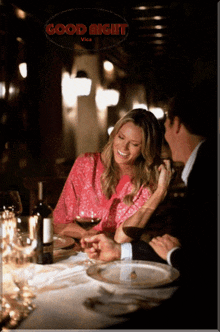 a picture of a man and woman sitting at a table with good night written on the bottom
