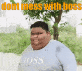 a very fat man wearing a shirt that says boss on it