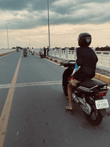 a man riding a scooter with a license plate that says 11-1560
