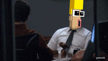 a man in a white shirt and tie talking to another man with a peacock logo on the bottom right