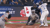 a baseball player with the number 27 on his back swings at a pitch