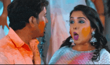 a man and a woman are looking at each other with a surprised look on her face