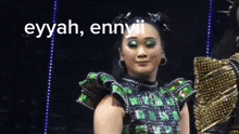 a woman in a green and gold outfit with the words " eyyah ennyii " on the bottom