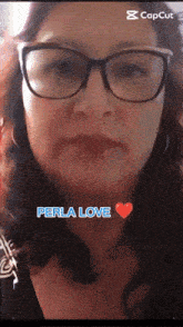 a woman wearing glasses says " perla love " in blue letters