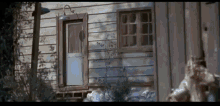 a very old house with a white door and windows