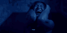 a woman is screaming in a dark room and the word help is on the bottom right